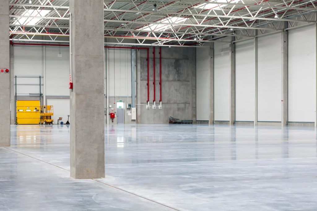 Large industrial facility with a coated concrete floor, illustrating durable protective coatings used to support long-term facility performance and reduced maintenance downtime.