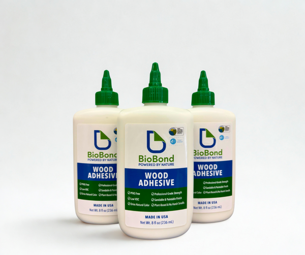 Three bottles of BioBond Wood Adhesive, a plant-based, low VOC adhesive designed for woodworking, cabinetry, furniture, and craft applications.