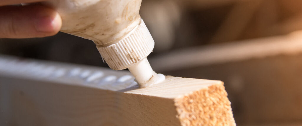White wood glue or adhesive on wood block
