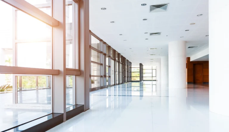 Bright, modern commercial interior with polished floors and natural light, representing facilities designed for safer and healthier material performance.